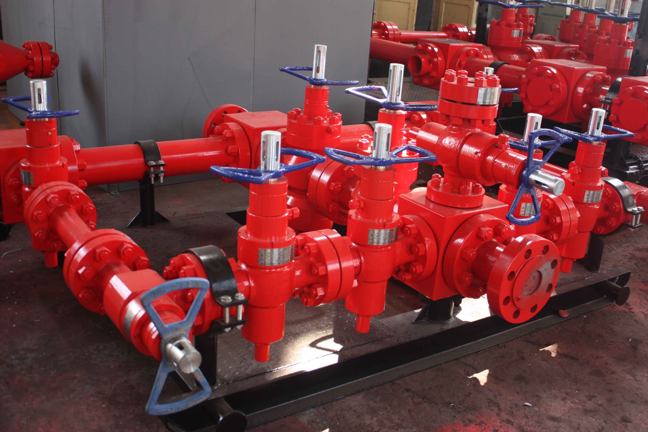 SGPE Drilling Mud Manifold connecting multiple mud pumps to a standpipe system with high-pressure mud gate valves, check valves, pressure gauges and skid-mounted piping on an oil and gas drilling rig